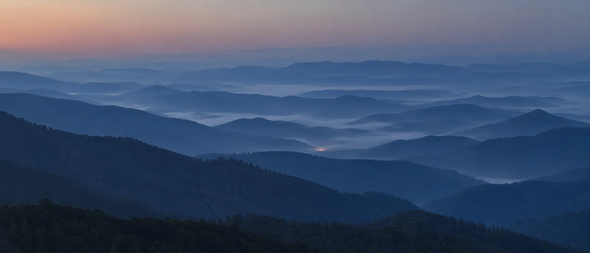Layered mountain ridgelines at dawn
